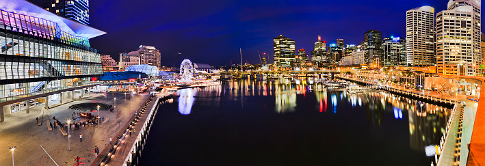 Dark blue panorama of Darling Harbour Cockle bay with surrounding high-rise buildings of urban architecture of modern city SYdney, Australia.