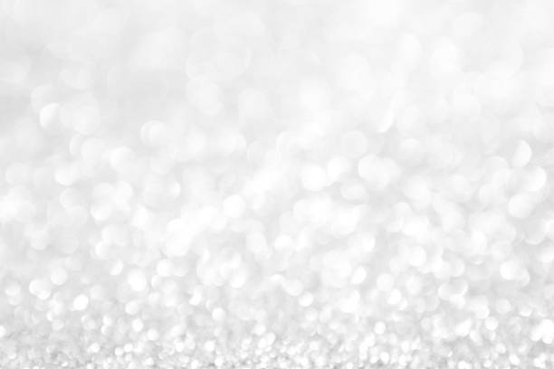 istock abstract background white Silver lights on christmas bokeh 1063175766