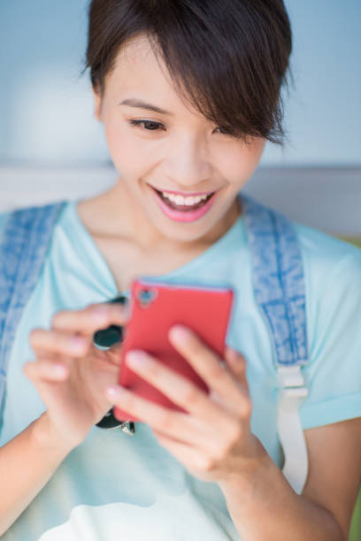 istock woman use phone happily 1063176016