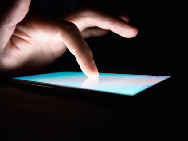 istock Hand touching on screen of smartphone on dark background. 1063190326