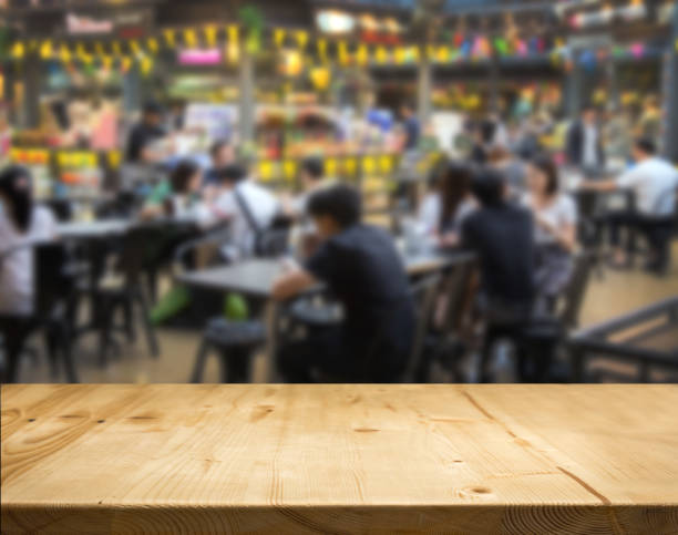 istock wood table counter with blurred food center 1063195836