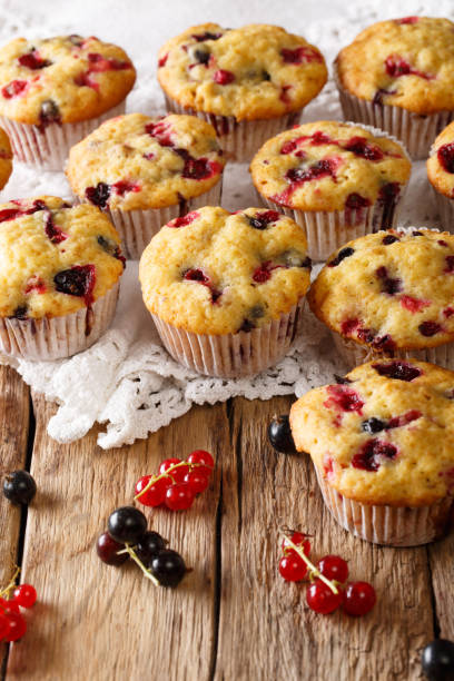 istock Fresh muffins with black and red currant berries close-up. vertical 1063196122