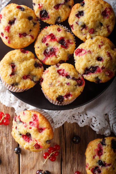 istock berry muffin with black and red currant close-up. Vertical top view from above 1063197204