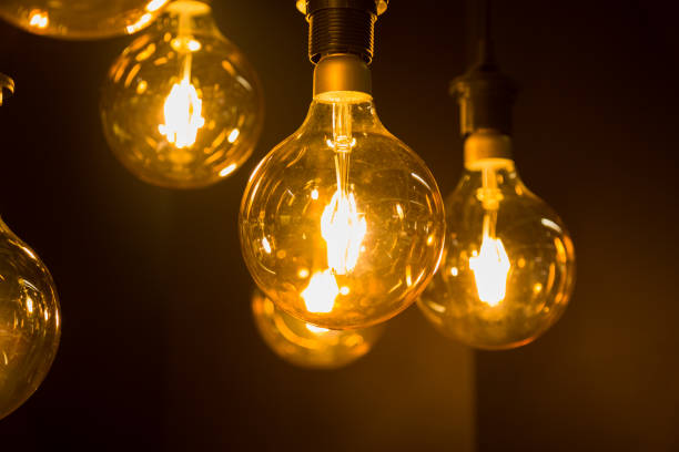 istock Cozy warm yellow light. Edison light bulb hanging. Closeup 1063199690