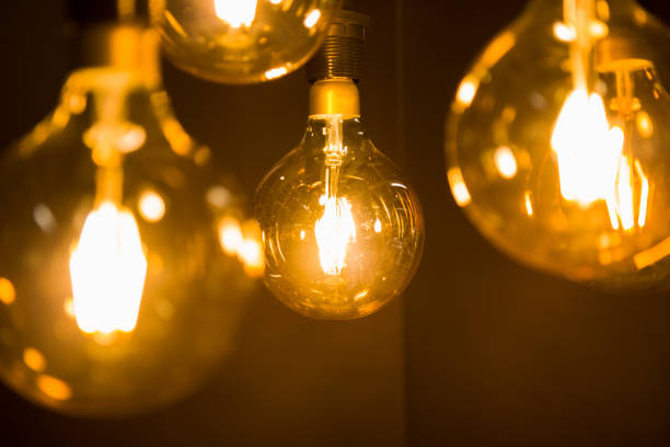 istock Cozy warm yellow light. Edison light bulb hanging. Closeup 1063199732