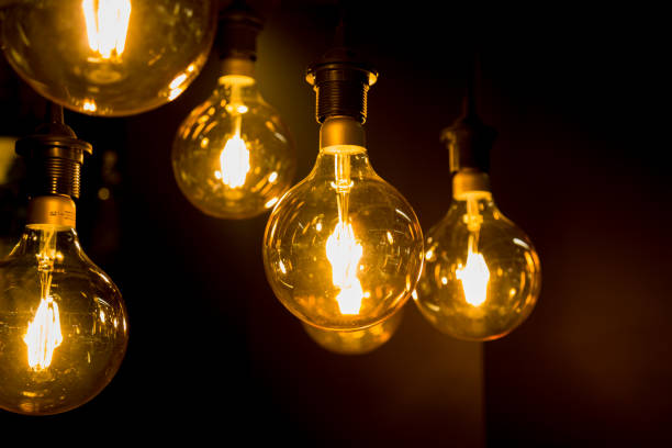 istock Cozy warm yellow light. Edison light bulb hanging. Closeup 1063200778