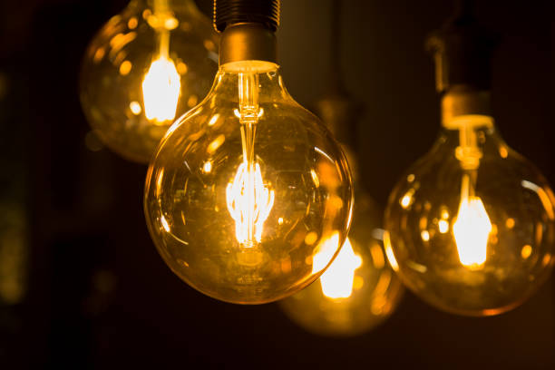 istock Cozy warm yellow light. Edison light bulb hanging. Closeup 1063200908