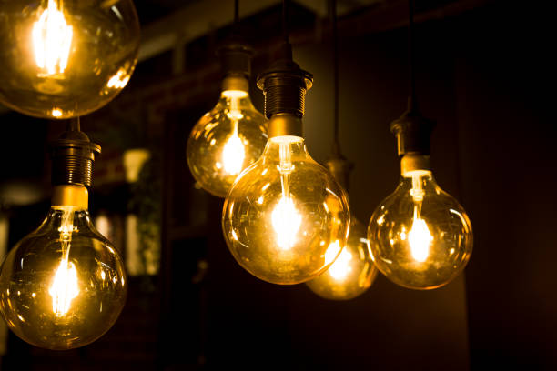 istock Cozy warm yellow light. Edison light bulb hanging. Closeup 1063200962