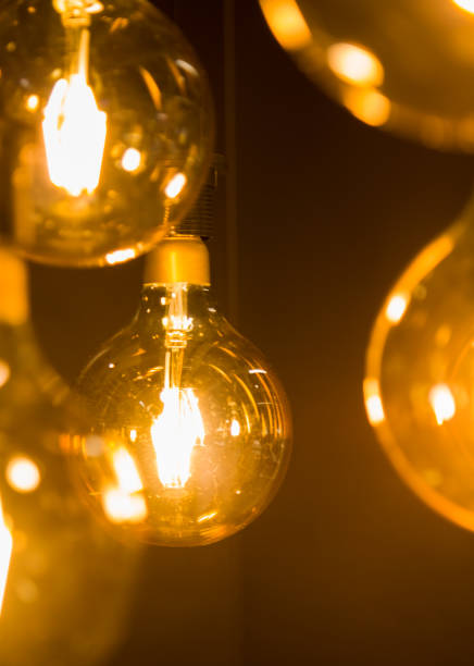 istock Cozy warm yellow light. Edison light bulb hanging. Closeup 1063200968