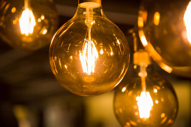 istock Cozy warm yellow light. Edison light bulb hanging. Closeup 1063200970