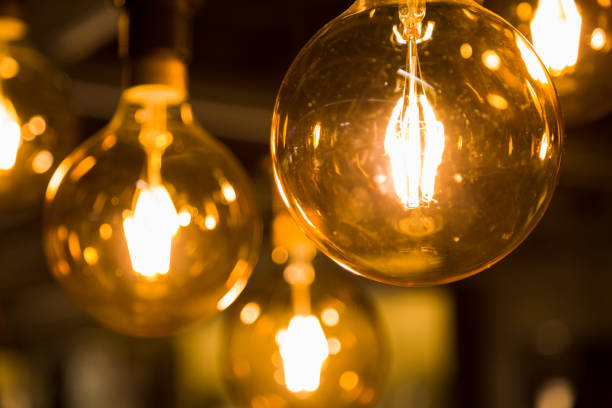 istock Cozy warm yellow light. Edison light bulb hanging. Closeup 1063201008