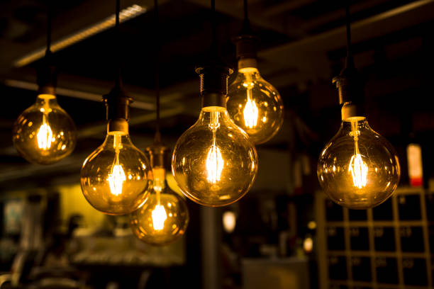 istock Cozy warm yellow light. Edison light bulb hanging. Closeup 1063201020