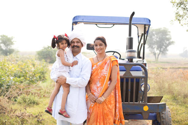 istock Family with tractor on field 1063201186