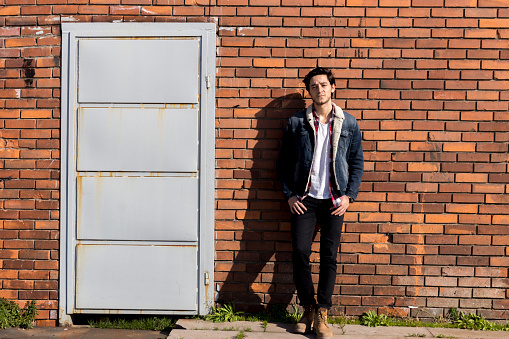 Young man leaning the wall