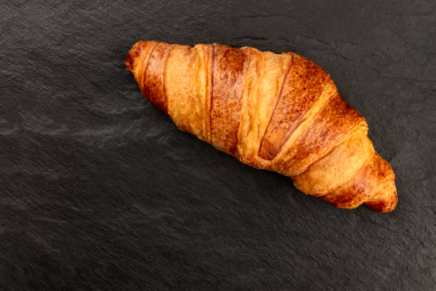 istock A croissant, shot from above on a black background with copy space 1063204672