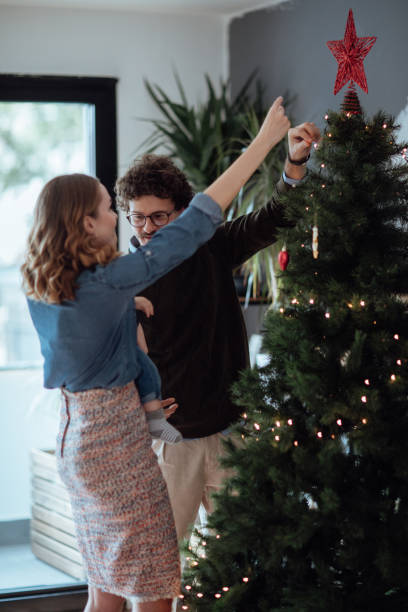 istock Happy family decorating Christmas tree 1063206436