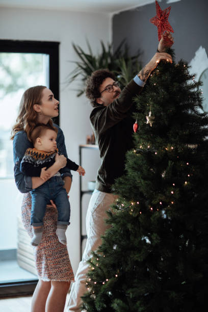 istock Happy family decorating Christmas tree 1063206440