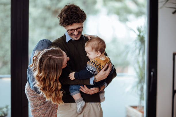istock Happy family decorating Christmas tree 1063206442