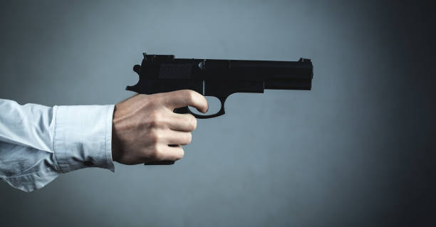 istock Male hand holding pistol. Criminal concept 1063207926