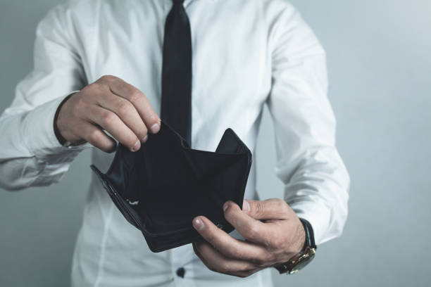 istock Businessman holding empty black leather wallet. 1063207928