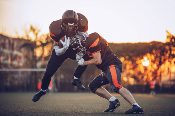 Winning match Group of American football players playing a match on a field offense sporting position photos stock pictures, royalty-free photos & images