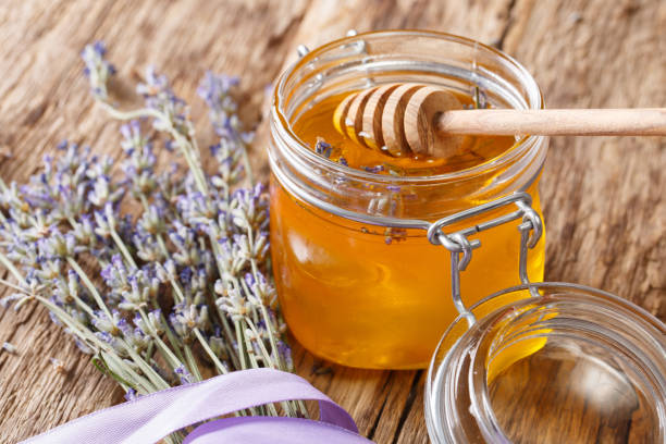 istock Lavender liquid honey in a glass jar close-up. horizontal 1063210656