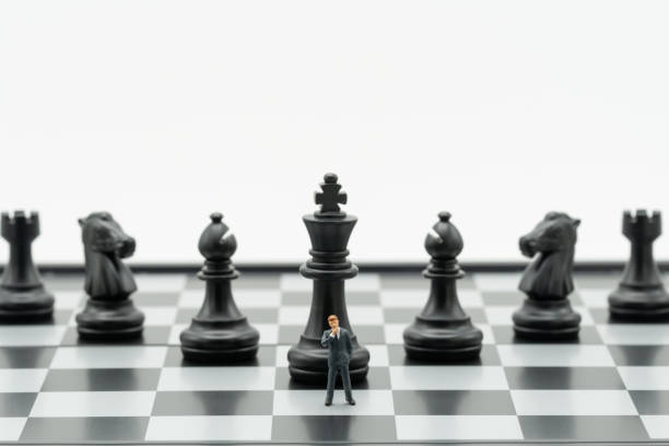 istock Miniature people businessmen standing Chess Analysis Communicate about business strategy. Or business planning using as background business concept and Strategy concept with copy space for your text. 1063221136