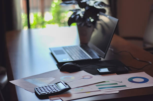 istock calculator with business graph and computer laptop on desk 1063228940