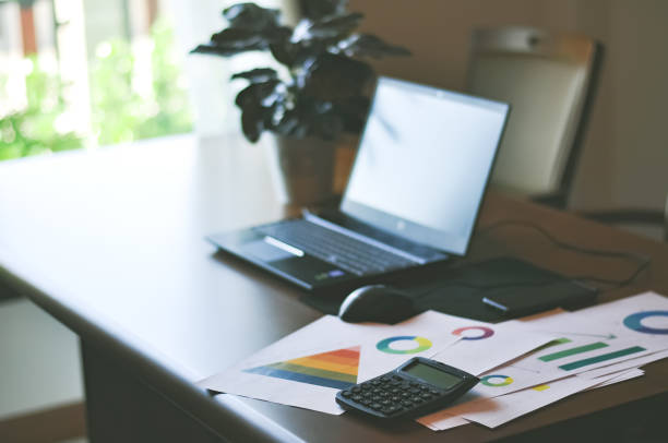istock calculator with business graph and computer laptop on desk 1063228944
