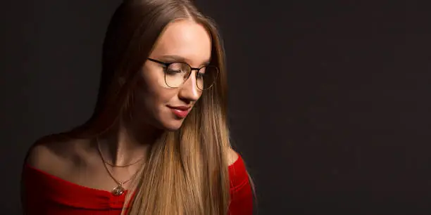 Beautiful blonde girl with long hair in glasses. European fashion model and natural beauty.