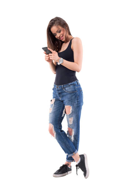 istock Happy relaxed young stylish woman smiling while using mobile phone 1063234818