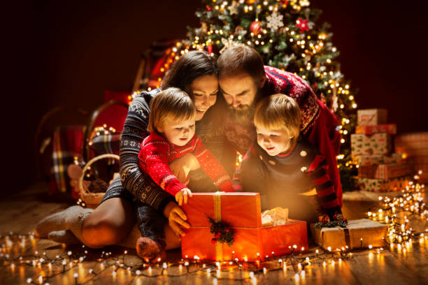 christmas family open lighting present gift box under xmas tree, happy mother father children - christmas tree christmas gift christmas present imagens e fotografias de stock