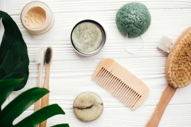 istock Zero waste flat lay. Solid shampoo bar, bamboo toothbrushes, wooden brush, natural deodorant and konjaku sponge on white wood with green monstera leaves. Eco friendly 1063241086