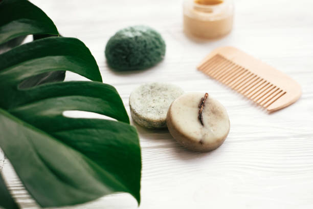 istock Zero waste solid shampoo bar, bamboo toothbrushes, wooden brush, natural deodorant and konjaku sponge on white wood with green monstera leaves. Eco  natural products plastic free 1063241738