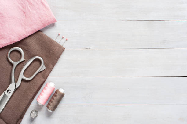 istock Sewing items and linen fabric on the table 1063242110