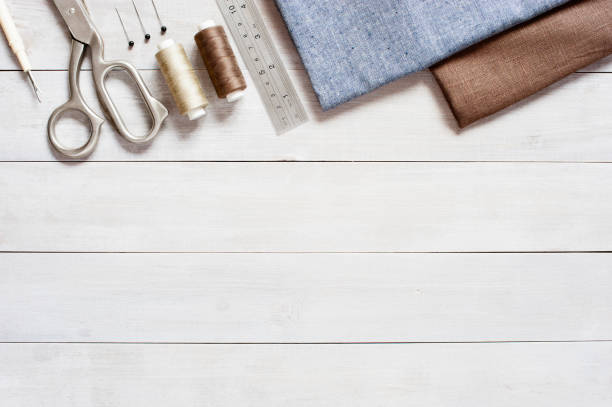 istock Sewing items on the light wooden table 1063242452