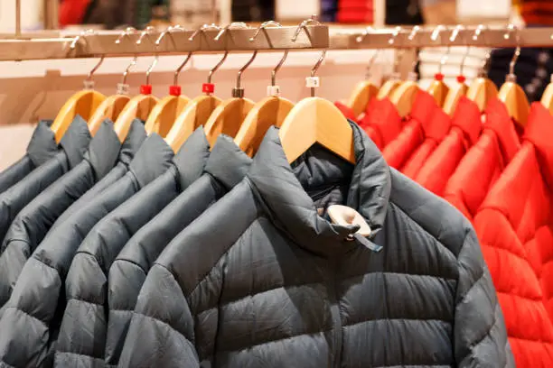 Winter jackets on a hanger in the store close-up