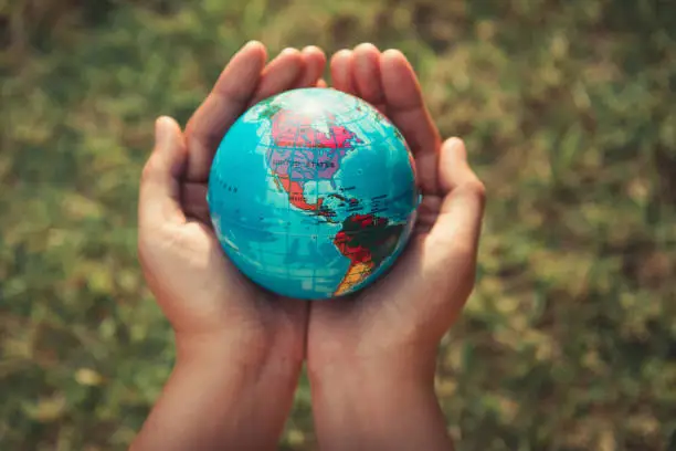 Photo of Save the earth concept, Woman hands is holding mockup the global on tree leave background