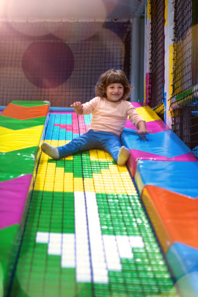 istock Smiling little Boy climbing and sliding on playground 1063259512