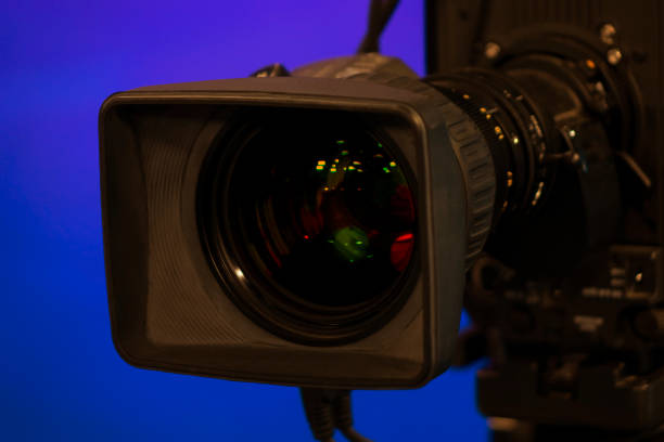 istock Close-up of a Television Camera lens in a blue screen studio environment. 1063259934