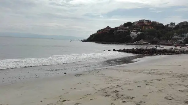 A beautiful scene of a beach in Mexico. Calm waves, soft sand & inviting locals.