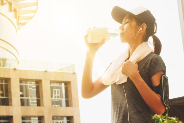 istock Young pretty woman finished running  drink water for refreshness 1063261590
