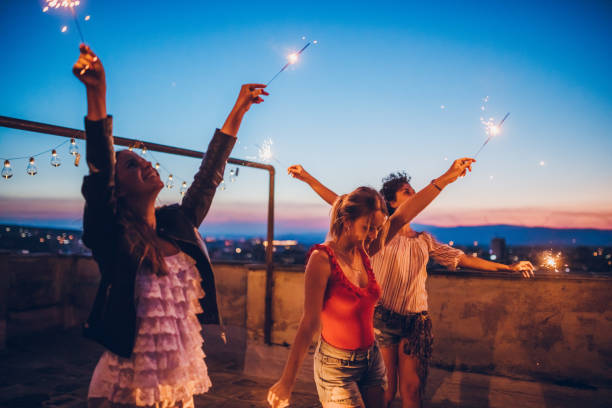 istock Rooftop party friends with sparklers 1063263120