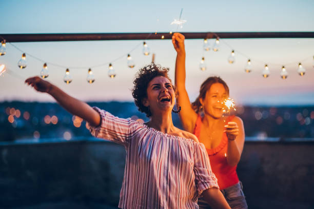 istock Rooftop party friends with sparklers 1063264354