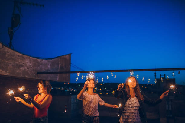 istock Rooftop party friends with sparklers 1063264774