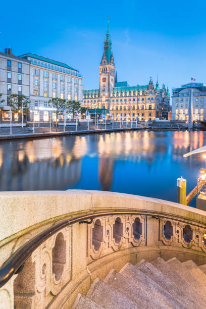 Hamburg city hall with Binnenalster at twilight, Germany Classic twilight view of Hamburg city center with historic town hall reflecting in Binnenalster during blue hour at dusk, Germany aussenalster lake stock pictures, royalty-free photos & images