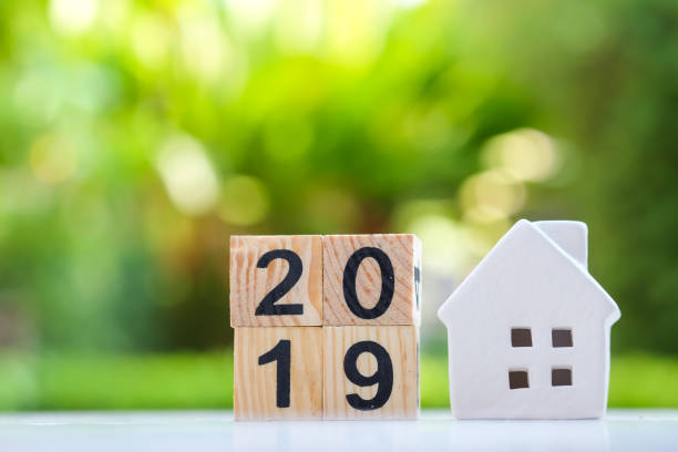 istock 2019 wood block number with white house model. 1063268662
