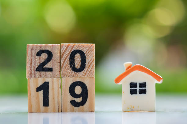 istock 2019 wood block number with mini house model. 1063268672