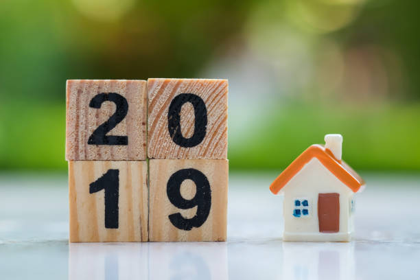 istock 2019 wood block number with mini house model. 1063268698