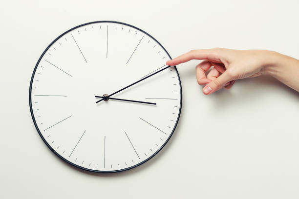 istock Woman hand stop time on a round clock, time management and deadline concept 1063270586
